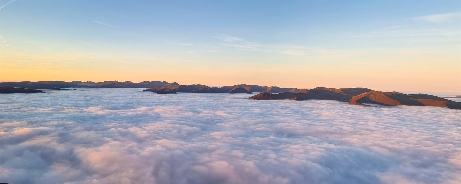 A cloud inversion seen from Skiddaw, with a sea of cloud filling the valleys below sunlit fell tops